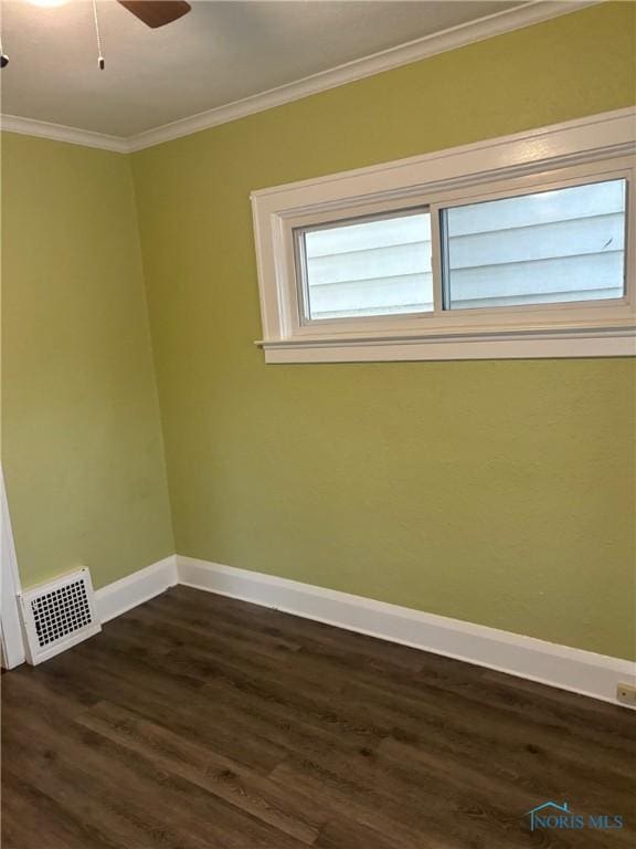 empty room with dark hardwood / wood-style floors, ceiling fan, and ornamental molding