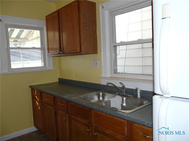 kitchen featuring white fridge and sink