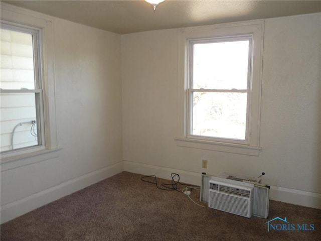 carpeted empty room featuring a wall mounted air conditioner