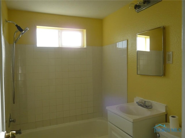 full bathroom featuring vanity, shower / bath combination, and plenty of natural light