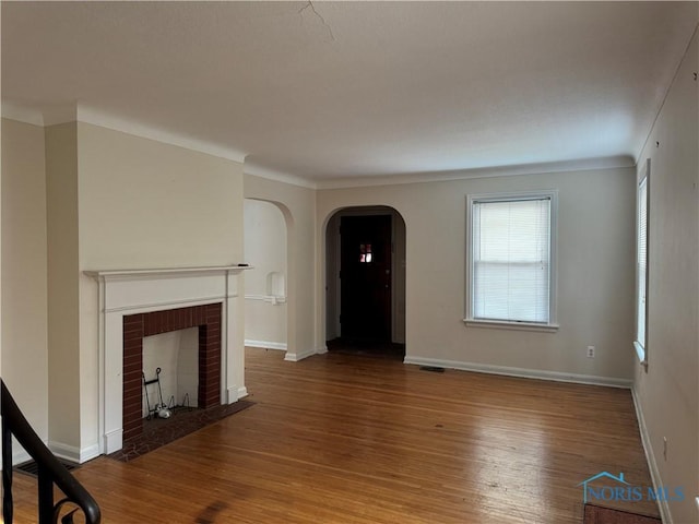 unfurnished living room featuring a fireplace and hardwood / wood-style floors