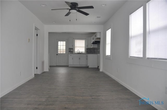 interior space featuring ceiling fan and dark hardwood / wood-style flooring