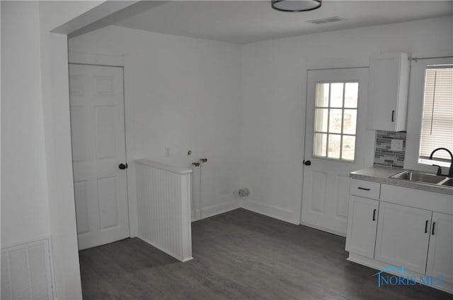 laundry room featuring sink, hookup for a washing machine, dark wood-type flooring, and cabinets