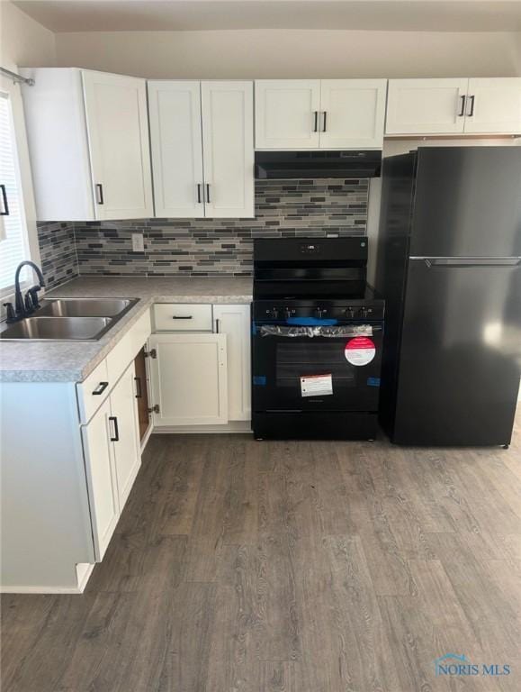 kitchen with dark hardwood / wood-style floors, sink, white cabinets, decorative backsplash, and black appliances