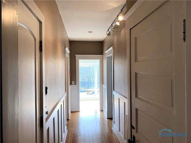 corridor featuring track lighting and light wood-type flooring