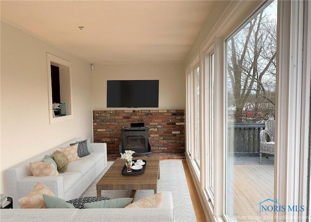 living room featuring a wood stove and light hardwood / wood-style flooring