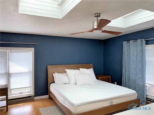 bedroom featuring ceiling fan and light hardwood / wood-style floors