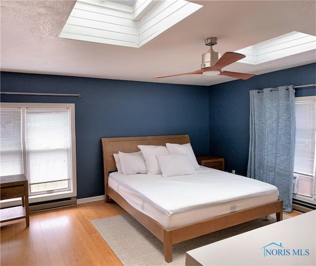 bedroom with ceiling fan and light hardwood / wood-style floors