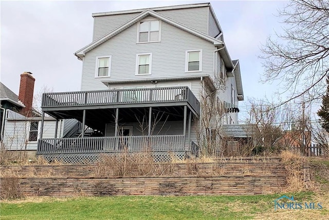 back of house featuring a deck