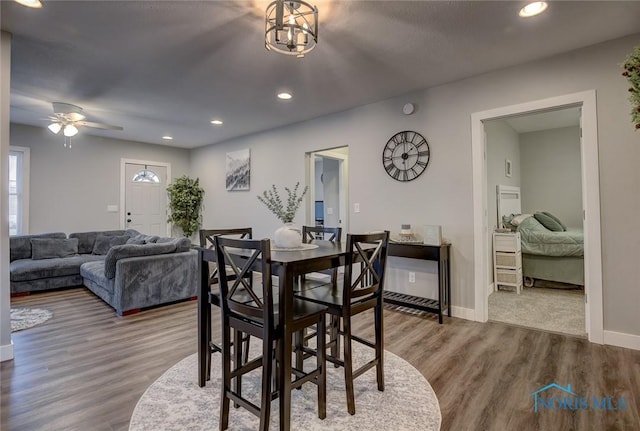 dining area featuring wood-type flooring and ceiling fan