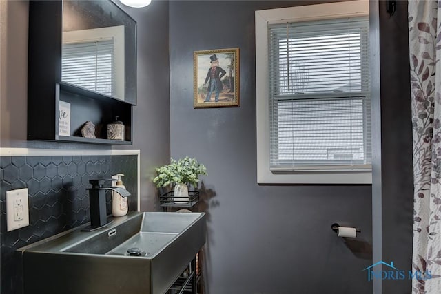 bathroom featuring decorative backsplash and sink