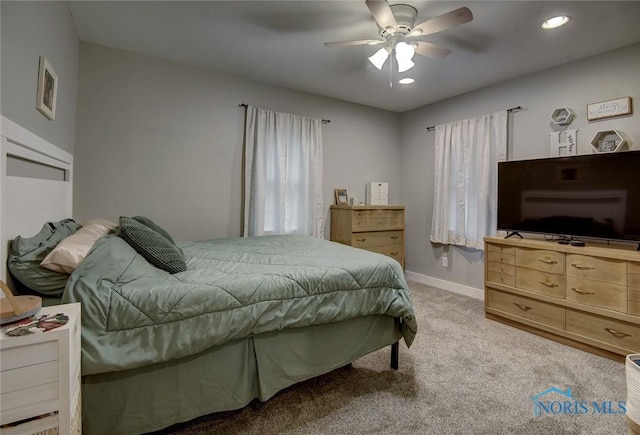 bedroom with ceiling fan and light colored carpet