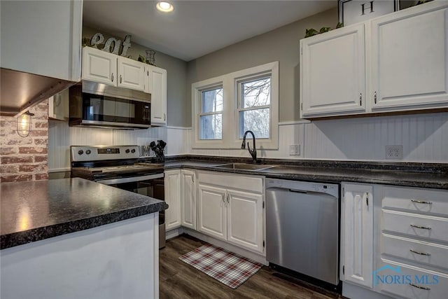 kitchen featuring white cabinets, dark hardwood / wood-style flooring, stainless steel appliances, and sink