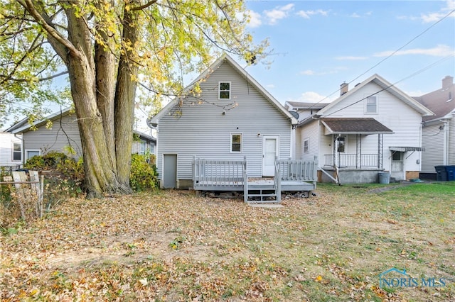 rear view of house featuring a wooden deck