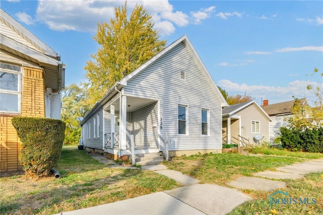 view of property exterior with a yard