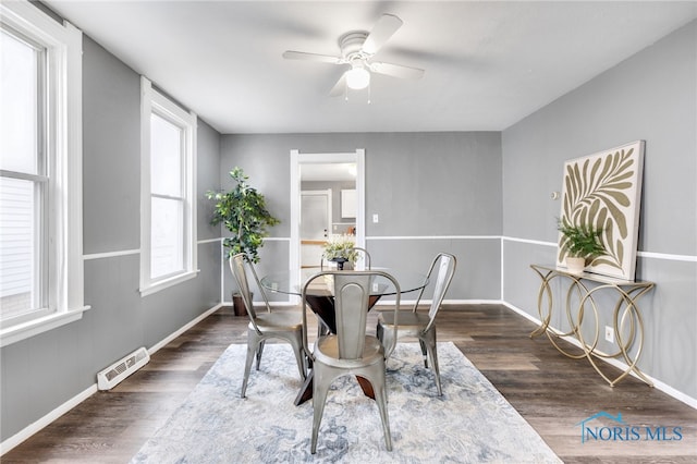 dining area featuring dark hardwood / wood-style flooring, ceiling fan, and a healthy amount of sunlight