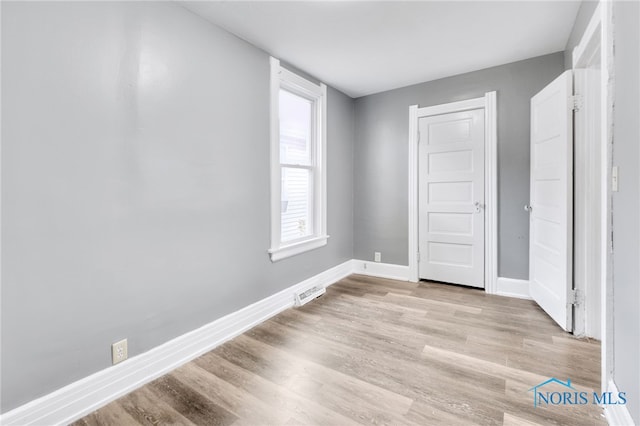 unfurnished bedroom featuring light wood-type flooring