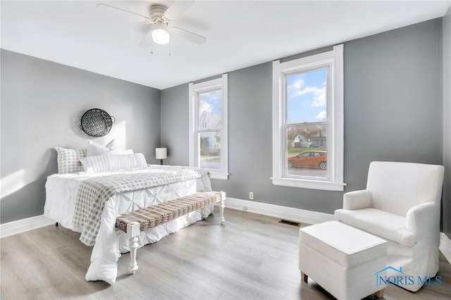 bedroom with ceiling fan and light hardwood / wood-style floors