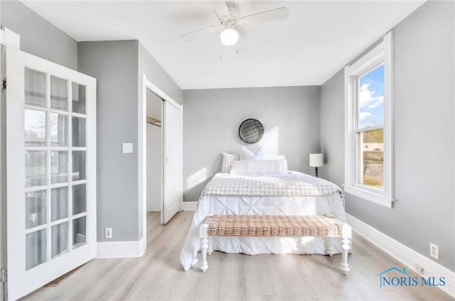 bedroom with light wood-type flooring, a closet, and ceiling fan