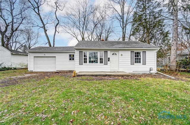 view of front of property with a front yard and a garage