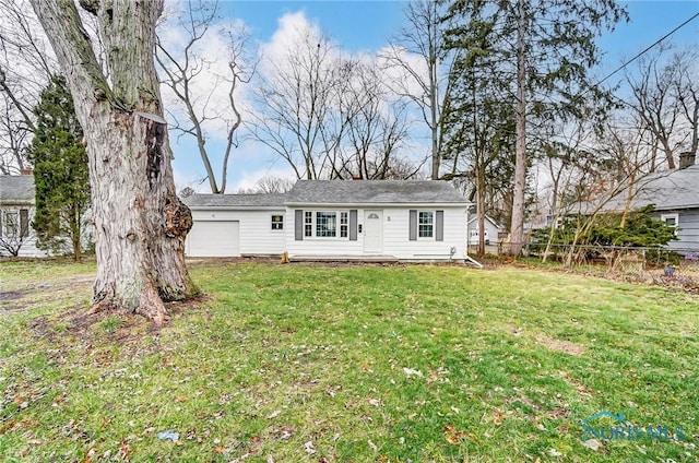 back of house with a lawn and a garage