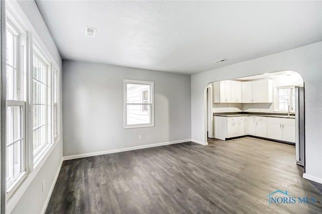 kitchen featuring white cabinets, sink, hardwood / wood-style floors, and stainless steel refrigerator