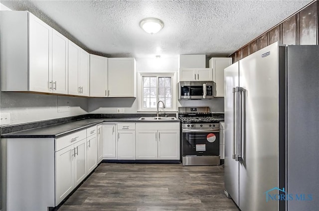 kitchen featuring white cabinets, dark hardwood / wood-style floors, sink, and appliances with stainless steel finishes