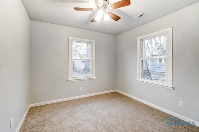 empty room with carpet flooring and ceiling fan