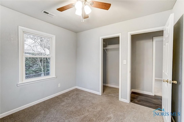 unfurnished bedroom with carpet flooring, ceiling fan, and a closet