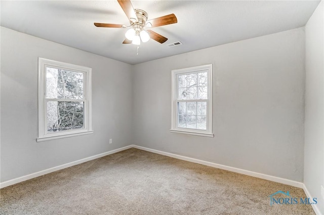 unfurnished room featuring ceiling fan and carpet floors