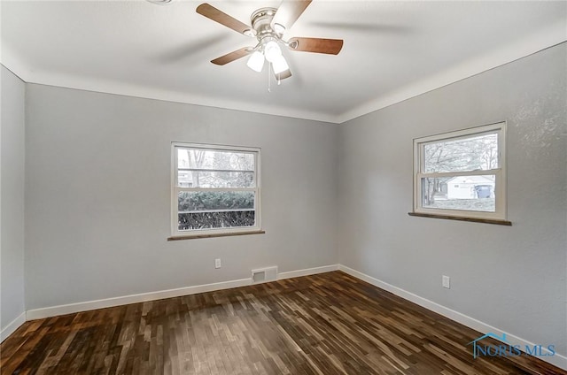 spare room featuring dark hardwood / wood-style floors and ceiling fan