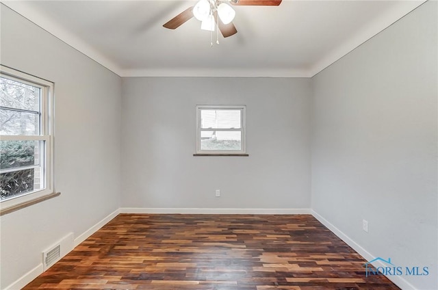 unfurnished room with ceiling fan and dark wood-type flooring