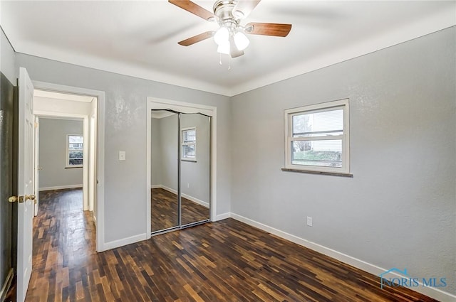 unfurnished bedroom featuring a closet, ceiling fan, and dark hardwood / wood-style floors