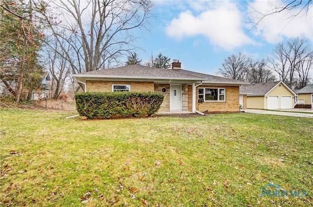 view of front of property with a front yard and a garage