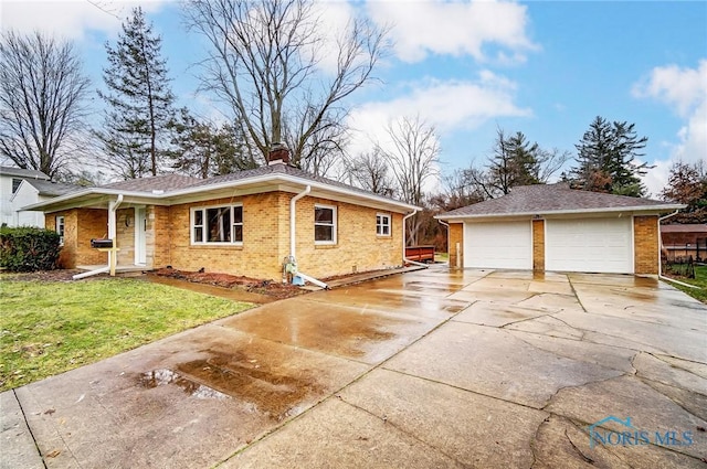 view of property exterior featuring a lawn, a garage, and an outbuilding