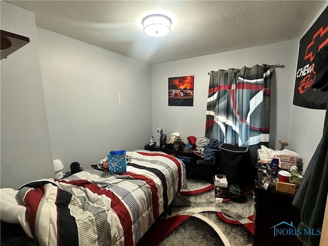 bedroom featuring carpet floors and a textured ceiling