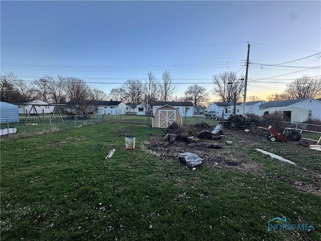 yard at dusk with a storage unit