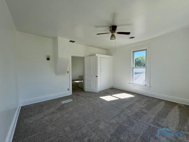 interior space featuring ceiling fan and dark colored carpet