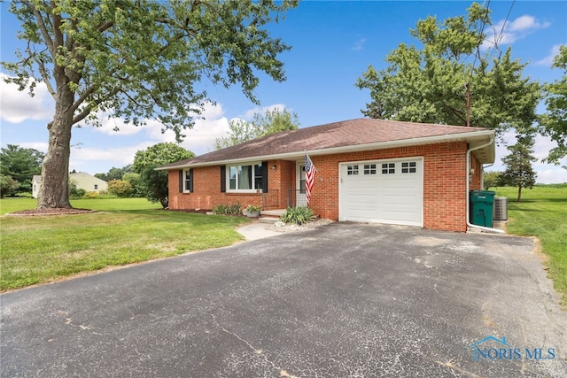 single story home with a front yard, central AC, and a garage