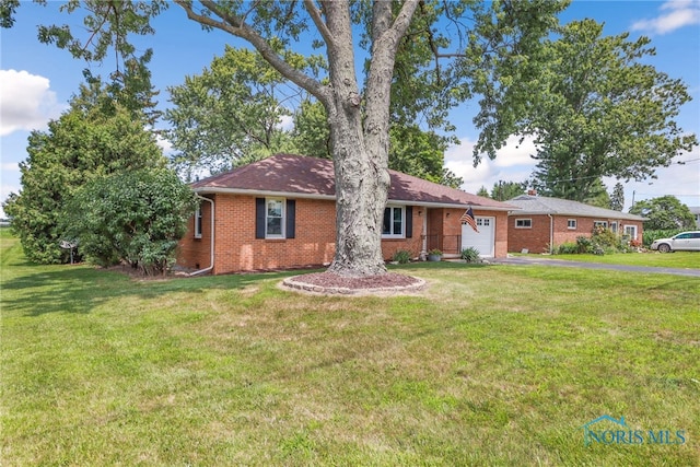 single story home featuring a garage and a front lawn