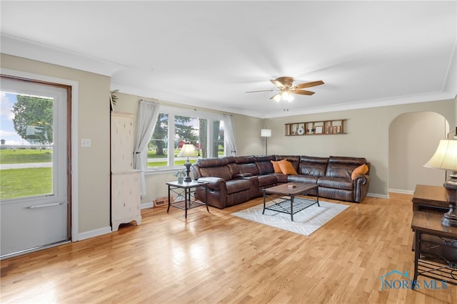 living room featuring plenty of natural light, ceiling fan, and crown molding