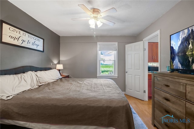 bedroom with ceiling fan and light hardwood / wood-style flooring