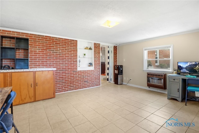 interior space featuring built in features, brick wall, heating unit, crown molding, and a textured ceiling