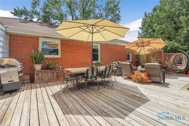 wooden terrace featuring a grill