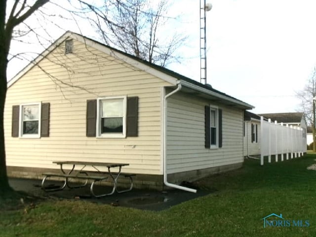 view of property exterior with a yard