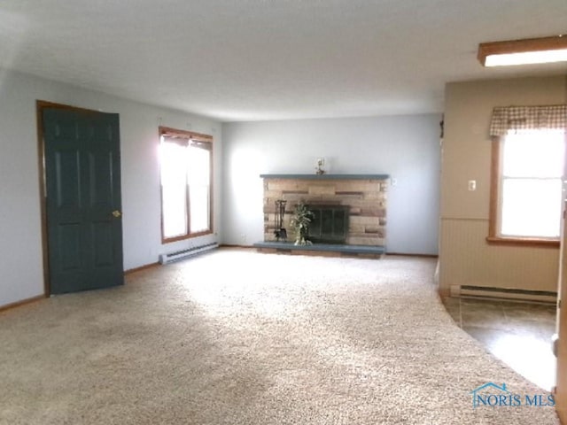 unfurnished living room with a fireplace, carpet flooring, and a baseboard radiator