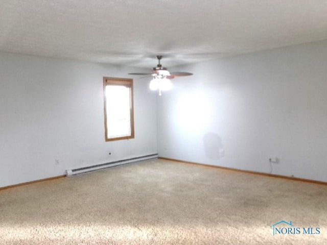 empty room featuring carpet flooring, ceiling fan, and a baseboard heating unit