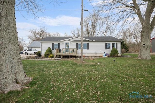 rear view of property with a yard and a deck