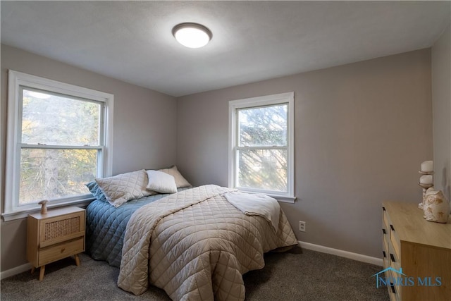 bedroom featuring dark colored carpet