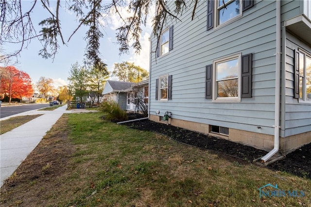 view of side of property with a lawn